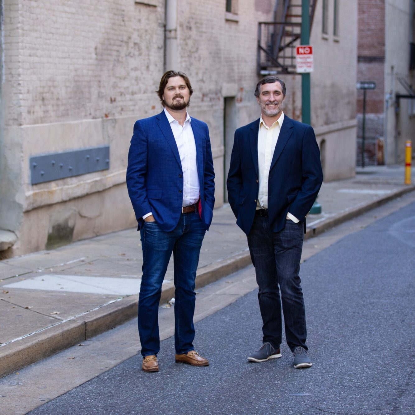 Two professionals standing confidently in a Memphis urban setting, representing Jones Aur Commercial Real Estate, showcasing expertise in commercial property for sale in Memphis, TN.